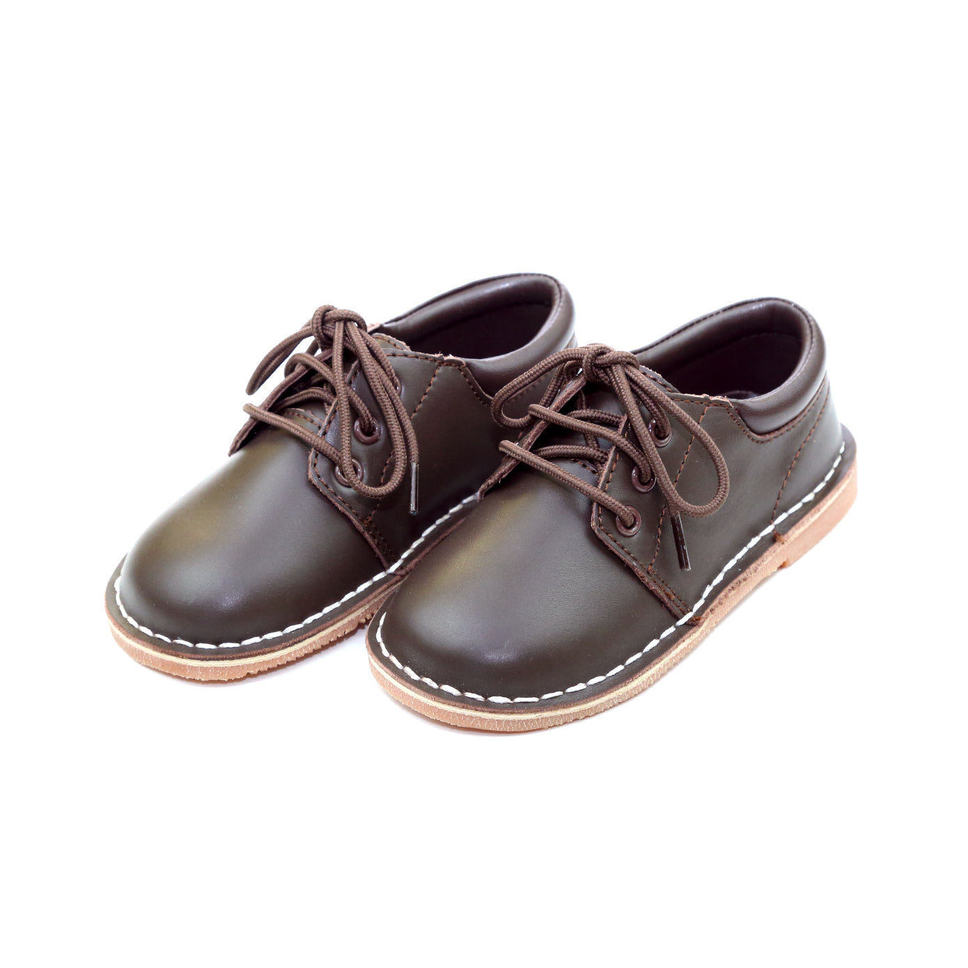 Tyler is a beautiful lace up shoe finely crafted from smooth leather, with functional matching lace front and stitch down construction. An absolutely handsome shoe for boys, this is our favorite shoe of choice for school, casual and dressy occasions. Smooth leather upper Matching laces Stitch down construction Breathable leather lining