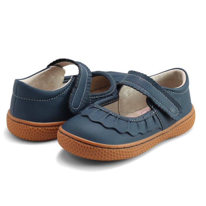 If we could only bottle the essence of Ruche... Would it be the ruffles? The scallops, the all-together dainty delightfulness? Whatever it is, she’s the perennially popular playground-to-party shoe. Crafted in soft heritage-quality leathers, she’s kid-tested and approved by the APMA (American Podiatric Medical Association), sure to withstand heavy play and support healthy foot development.