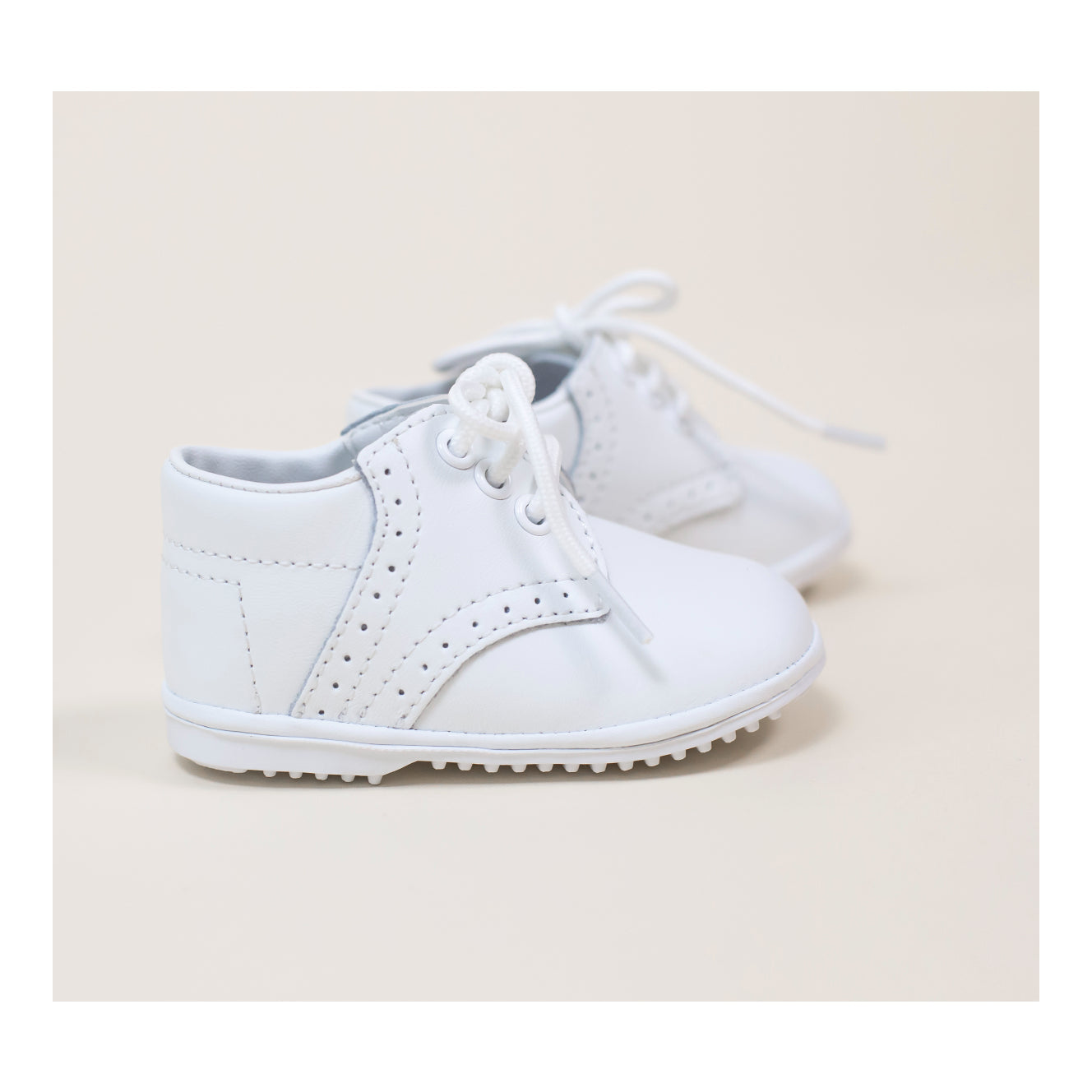 James is one of our oldest styles, a tribute to classic shoes in sturdy leather. This is our favorite go to shoe for any occasion, from Easter to Baptism to Christmas. Fit your little gent's toes into this shoe, and he will be charming everyone coming his way. Leather upper Functional lace through tonal grommets Simple brogue detailing and trim