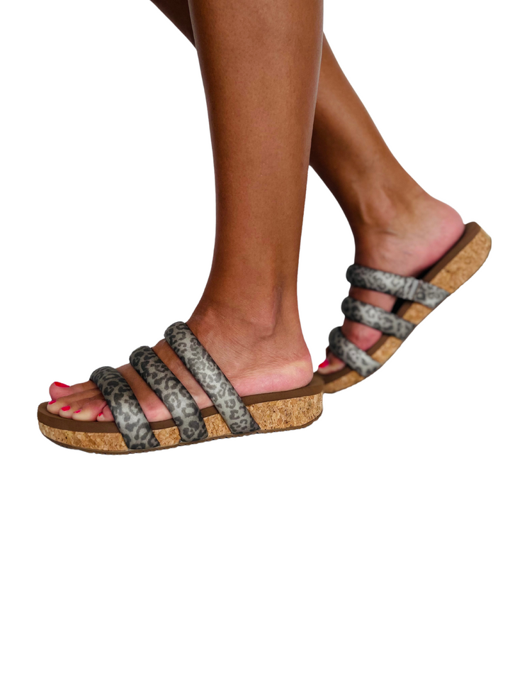 Volatile’s Gillette gives a modern feel with its asymmetrical upper in vegan leather and attractive metal adjustable buckle and clog stud accents. Featuring our signature ultra comfort EVA insole resting atop a moderate 2” cork wedge with rubber traction outsole for stability. Perfect with maxi dresses and boyfriend jeans alike.