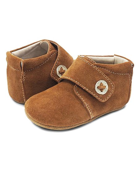 Help your little one step through the day in lightweight comfort with these booties offering a breathable leather lining and padded elastic collar for easy on and off. Padded elastic collar Suede upper Leather lining Rubber sole Imported