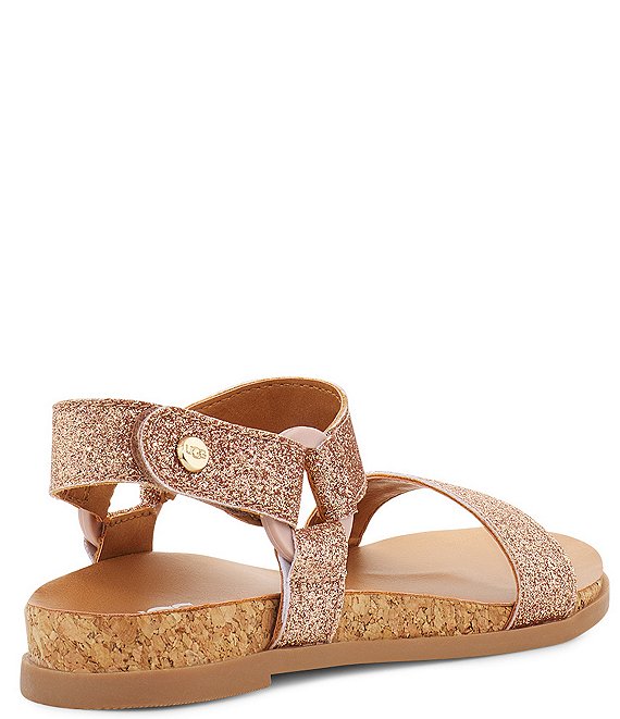 From UGG®, the Girls' Rynell Glitter Sandals feature: Synthetic glitter upper Elastic gore, TPU ring Hook-and-loop closure, adjustable ankle strap Synthetic lining Synthetic sockliner TPR outsole UGG is defined for those who refuse to be defined by convention