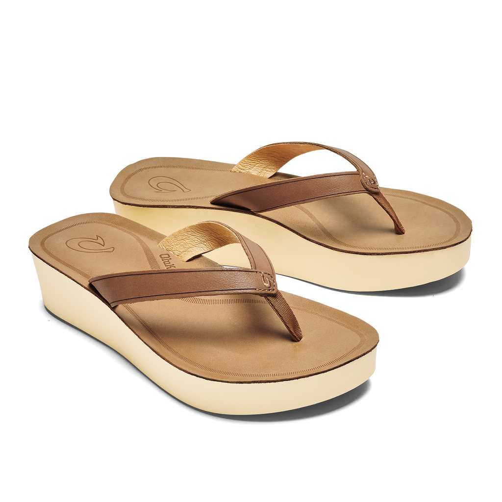 Simplicity is beauty with this clean, comfy, and easy-to-wear wedge sandal. Inspired by the calm serenity of a cloudless sky, Māla‘e is the perfect easygoing companion for lounging by the beach or meandering around town.  UPPER Soft, full-grain leather straps and a bonded microfiber lining create an ultra-comfy fit. The laser-etched strap details, embroidered logo, and custom-molded metal hook logo add custom style.