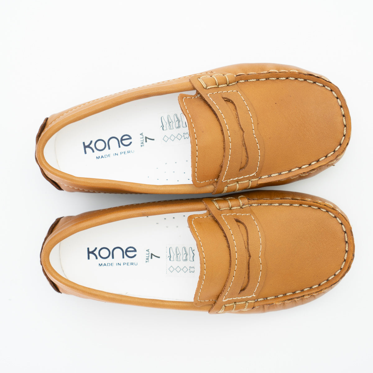 Kone boys’ leather loafers offer the ultimate combination of style, elegance, and comfort. The classic modeling intersects with the highest quality materials and expert craftsmanship. Whether you dress them up or dress them down, your little prince will shine in his Kone leather loafers!  Leather upper Slip-on penny loafer design for quick and easy on and off Breathable lining and a cushioned insole Driver style sole Made in Peru