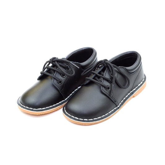 Tyler is a beautiful lace up shoe finely crafted from smooth leather, with functional matching lace front and stitch down construction. An absolutely handsome shoe for boys, this is our favorite shoe of choice for school, casual and dressy occasions.  Smooth leather upper Matching laces Stitch down construction Breathable leather lining