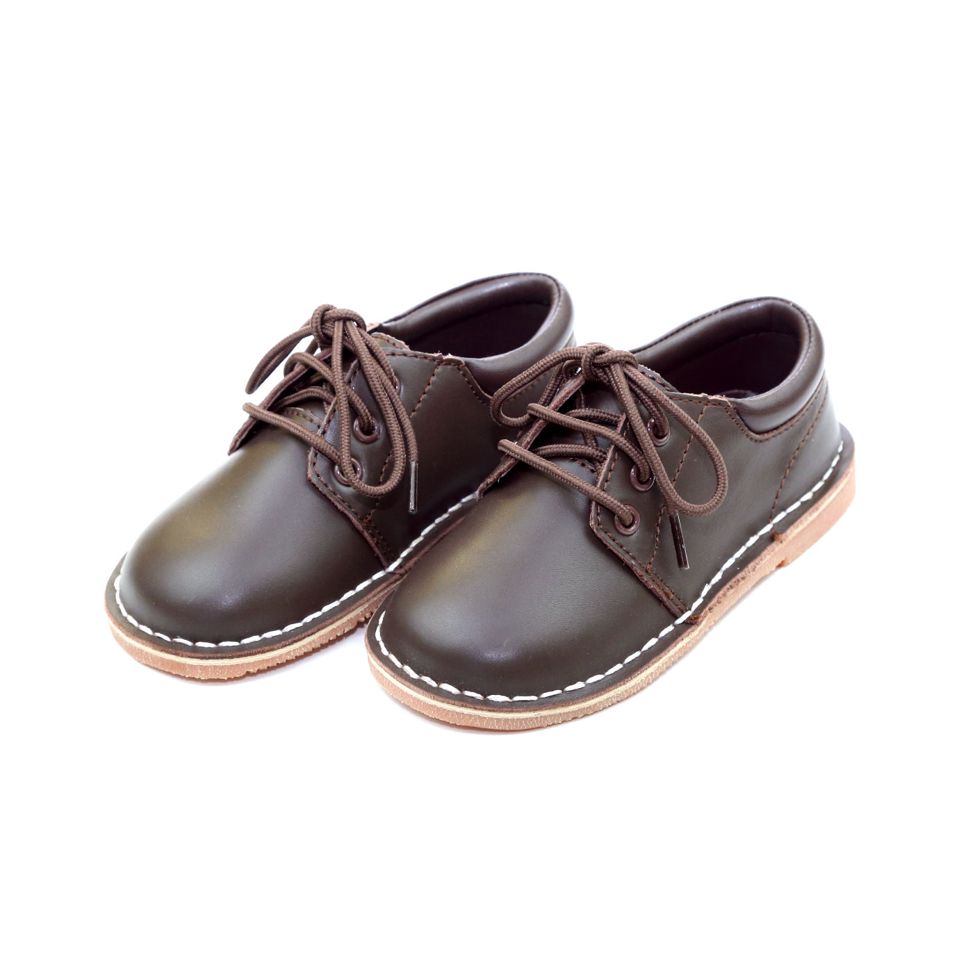 Tyler is a beautiful lace up shoe finely crafted from smooth leather, with functional matching lace front and stitch down construction. An absolutely handsome shoe for boys, this is our favorite shoe of choice for school, casual and dressy occasions.  Smooth leather upper Matching laces Stitch down construction Breathable leather lining