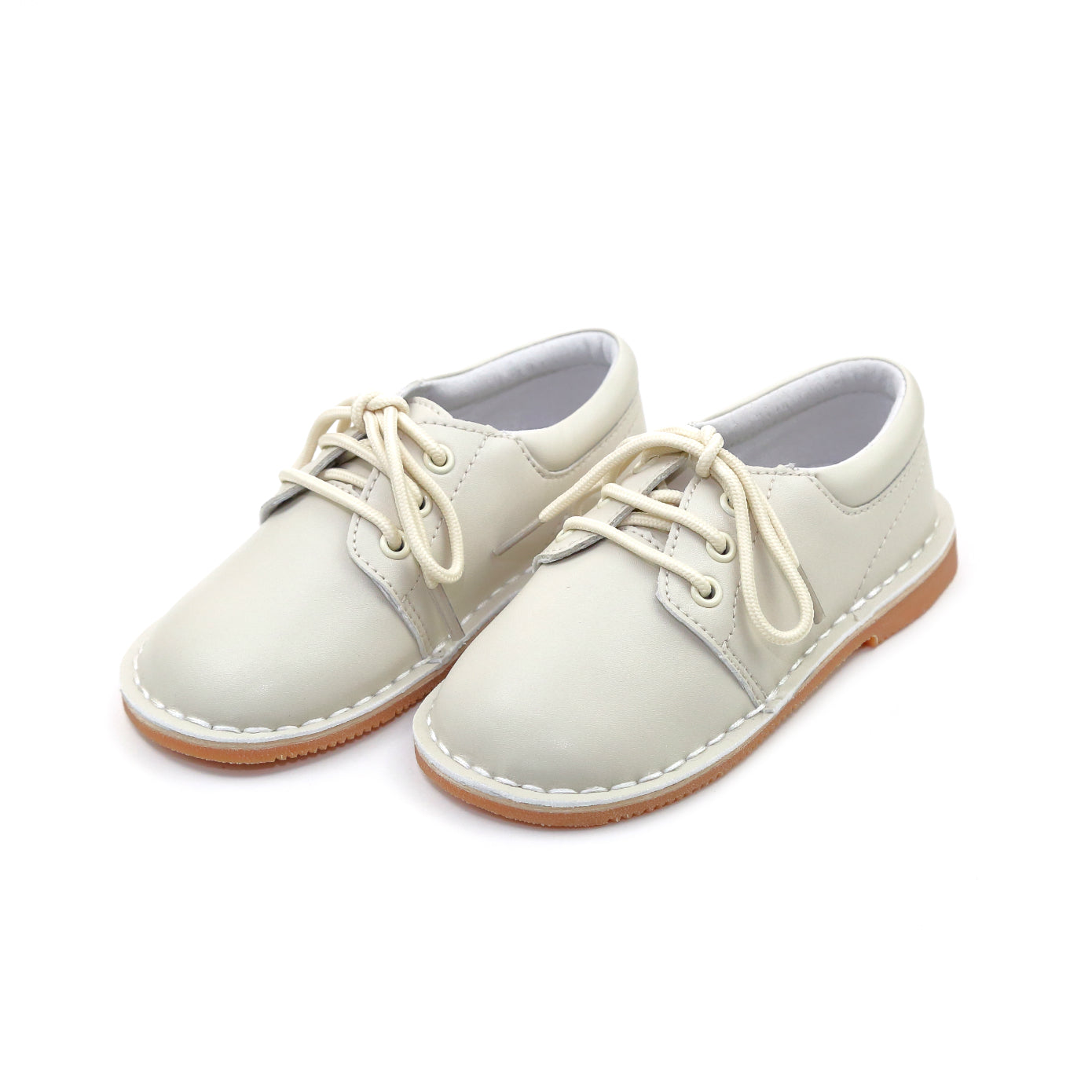 Tyler is a beautiful lace up shoe finely crafted from smooth leather, with functional matching lace front and stitch down construction. An absolutely handsome shoe for boys, this is our favorite shoe of choice for school, casual and dressy occasions.  Smooth leather upper Matching laces Stitch down construction Breathable leather lining