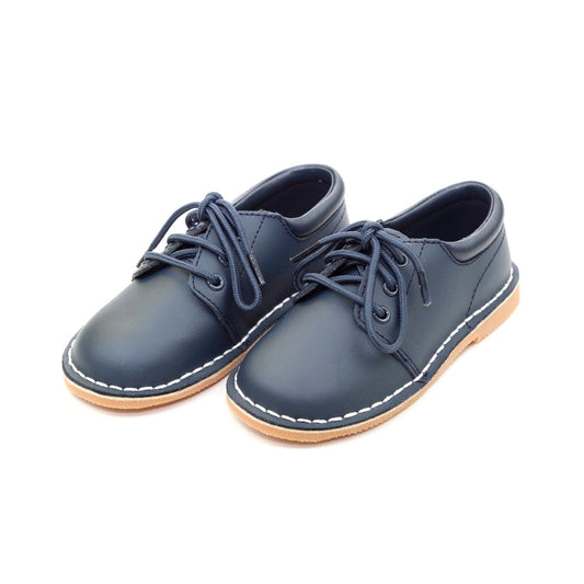 Tyler is a beautiful lace up shoe finely crafted from smooth leather, with functional matching lace front and stitch down construction. An absolutely handsome shoe for boys, this is our favorite shoe of choice for school, casual and dressy occasions.  Smooth leather upper Matching laces Stitch down construction Breathable leather lining
