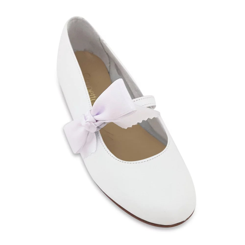 The feminine satin bow detail in this white  shoe  will perfectly complement any outfit.  With the bow  the shoe will be perfect for attending any party, holiday, or wedding. You can remove the bow and your child will be ready to walk to school.  Its soft leather construction promotes natural movement and proper foot development.  They have a rubber sole, and cushioned insole.  Each Geppetto’s shoe is handcrafted by our expert shoemakers with only the finest luxury materials.