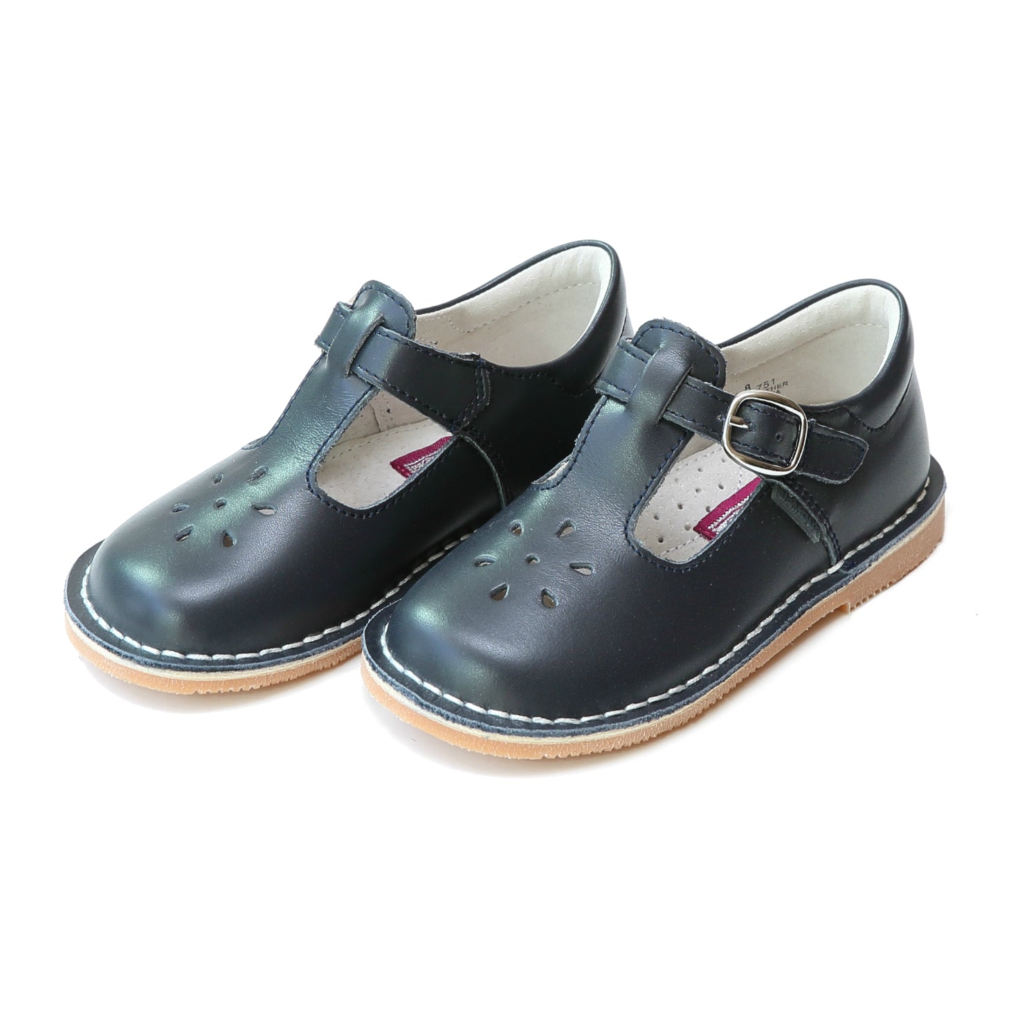 Joy, with its t-strap and perforated design, is an impeccable timeless shoe. With our array of colors, this mary jane can become your child's favorite for any special or casual occasion!  Stitch down construction Hook and loop velcro closure Breathable leather lining and sock with arch support