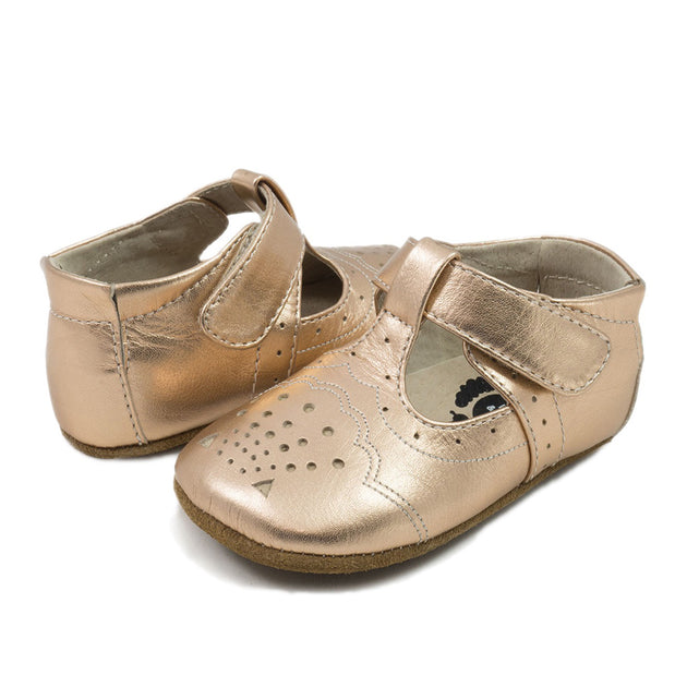 Swoon, this baby shoe is so delicate and scrumptious she could charm an ogre…  With pops of cream behind the tiny perforations, Cora is all about beauty in the details - a perfect little shoe for a special celebration or just because.  Stage: crawling, cruising & first steps Buttery-soft leather upper Natural leather lining Adjustable hook-and-loop closure for a tailored fit Padded elastic heel collar for easy on and off Suede outsole Best suited for indoor use and light outdoor activity