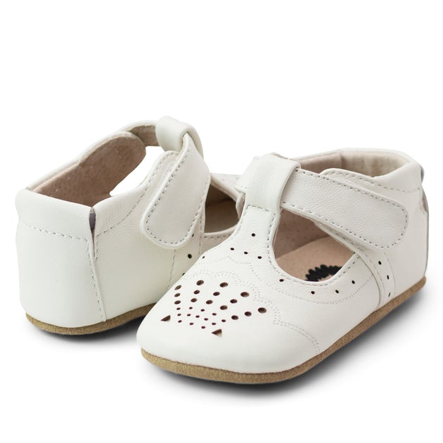 Swoon, this baby shoe is so delicate and scrumptious she could charm an ogre…  With pops of cream behind the tiny perforations, Cora is all about beauty in the details - a perfect little shoe for a special celebration or just because.  Stage: crawling, cruising & first steps Buttery-soft leather upper Natural leather lining Adjustable hook-and-loop closure for a tailored fit Padded elastic heel collar for easy on and off Suede outsole Best suited for indoor use and light outdoor activity