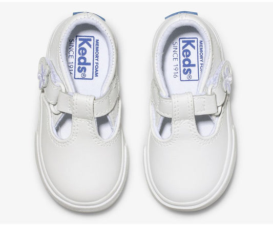 A T-strap twist on the classic Keds’ sneaker, the Daphne will go with whatever she chooses to wear that day. She’ll love the cute flower detail on the easy T-strap closure, and the memory foam footbed will keep her comfy while she braves the day.