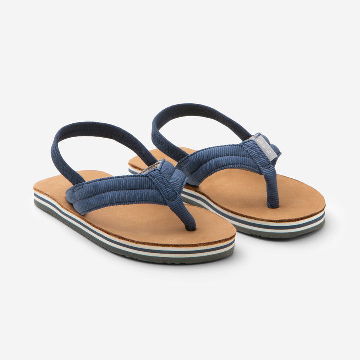 A go-to for kids of all ages, the Scouts are built to last. These leather and nylon flip flops come in a variety of colors that match every personality and closet. Step out in style, without having to lace up!              Sizes up to 8/9 have heel strap 