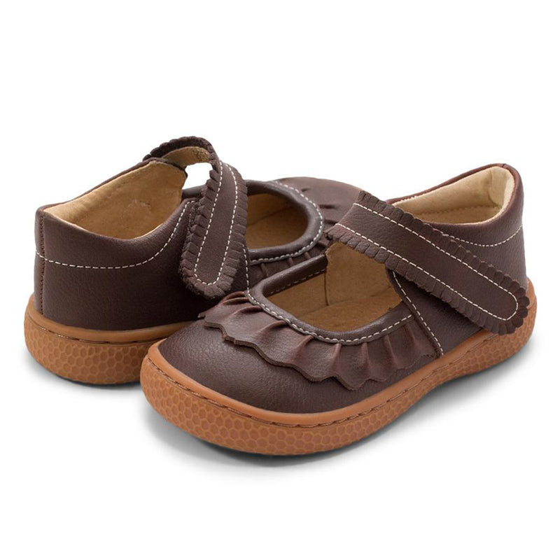 If we could only bottle the essence of Ruche... Would it be the ruffles? The scallops, the all-together dainty delightfulness? Whatever it is, she’s the perennially popular playground-to-party shoe.  Crafted in soft heritage-quality leathers, she’s kid-tested and approved by the APMA (American Podiatric Medical Association), sure to withstand heavy play and support healthy foot development.