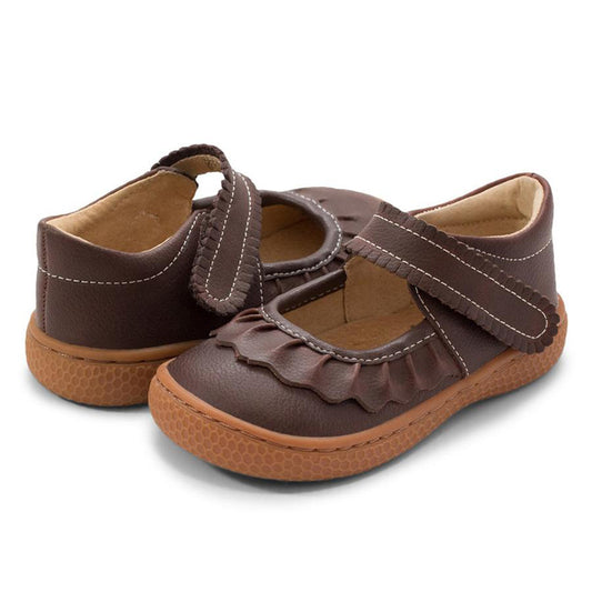 If we could only bottle the essence of Ruche... Would it be the ruffles? The scallops, the all-together dainty delightfulness? Whatever it is, she’s the perennially popular playground-to-party shoe.  Crafted in soft heritage-quality leathers, she’s kid-tested and approved by the APMA (American Podiatric Medical Association), sure to withstand heavy play and support healthy foot development.
