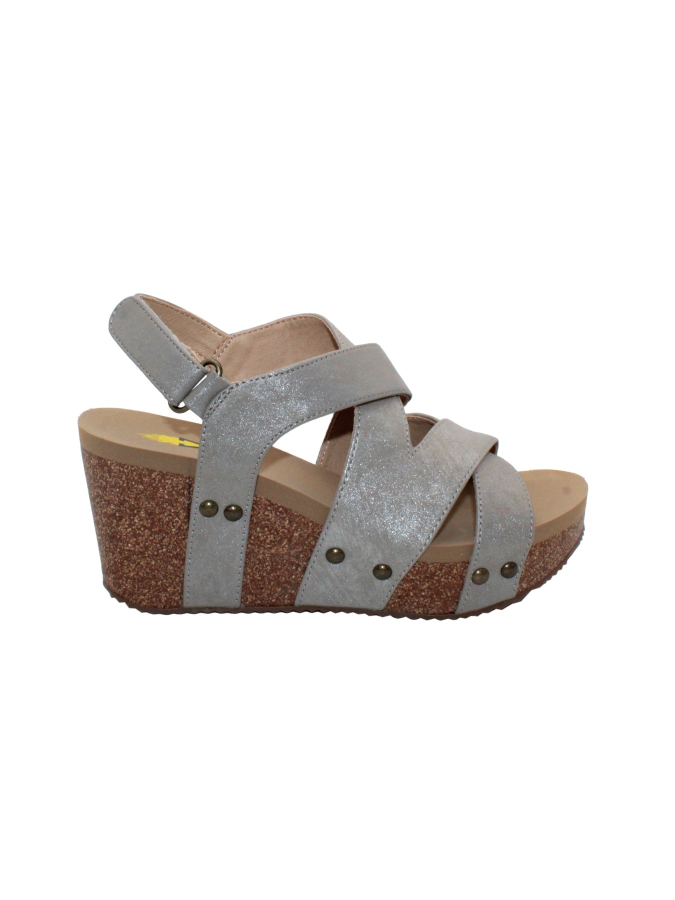 a modern feel with its asymmetrical upper in vegan leather and attractive metal adjustable buckle and clog stud accents. Featuring our signature ultra comfort EVA insole resting atop a moderate 2” cork wedge with rubber traction outsole for stability. Perfect with maxi dresses and boyfriend jeans alike.